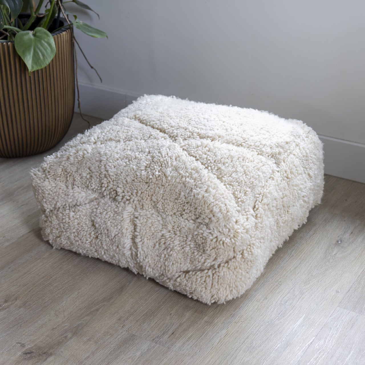 Poef met witte lijnen handgemaakt van wol